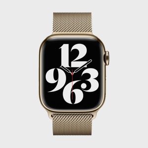 A gold smartwatch displays large retro numbers on a black face with sleek, modern clock hands, set against a plain white background.