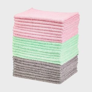 Stacked microfiber cloths sit in three colored layers: pink, green, and gray, on a plain white background.