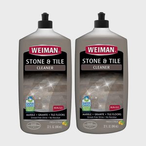 Two bottles display stone and tile cleaner labels; each bottle emphasizes streak-free shine and fresh citrus scent in a neutral background.