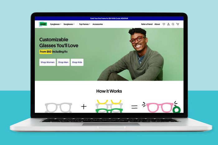 Laptop displays customizable glasses ad, featuring smiling man wearing glasses; price starts at $60. Surrounding context: green background, online shopping categories.