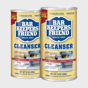 Two cylindrical cleanser cans display the 