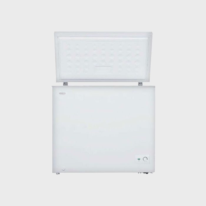 A white chest freezer stands open against a plain background, revealing an empty interior.