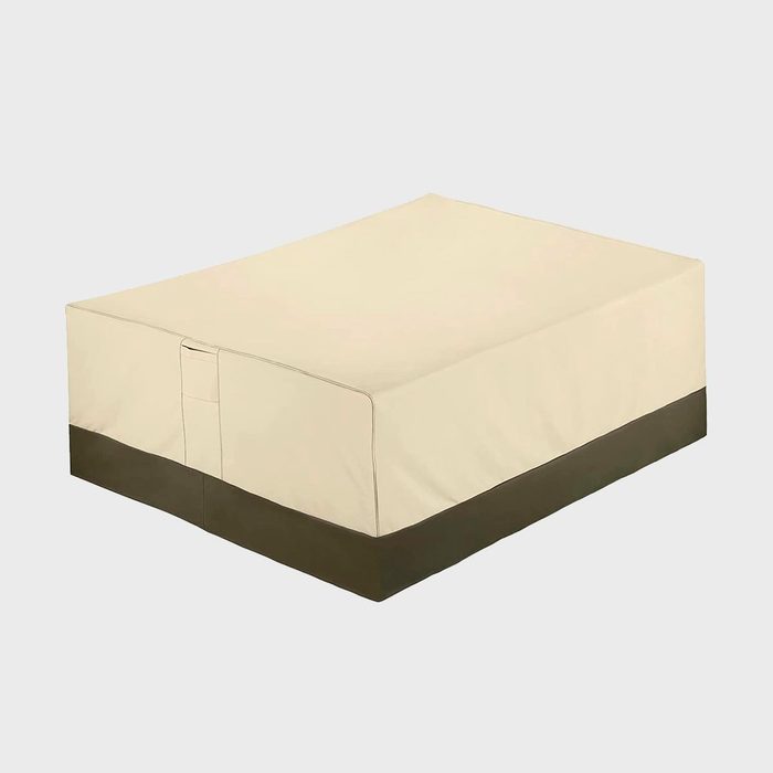 Rectangular beige cover sits on a surface, featuring a dark brown bottom edge against a plain background.