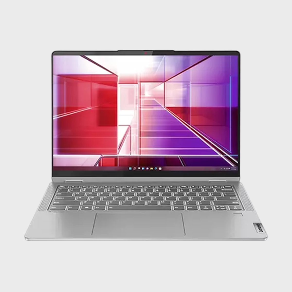 Laptop displaying colorful geometric graphics, sitting on a light gray surface. The environment is minimalistic with a white background.