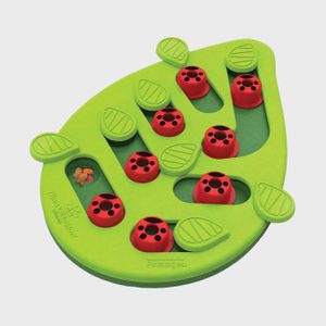 Green leaf-shaped puzzle with red ladybug pieces covering holes, surrounded by moveable leaf tabs. Text: â€œPetstages,â€ â€œNina Ottosson.â€