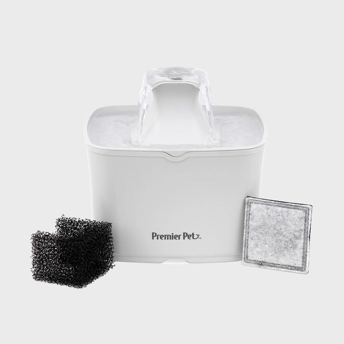 Water fountain flowing beside black sponges and square filter on a white background, featuring the text 