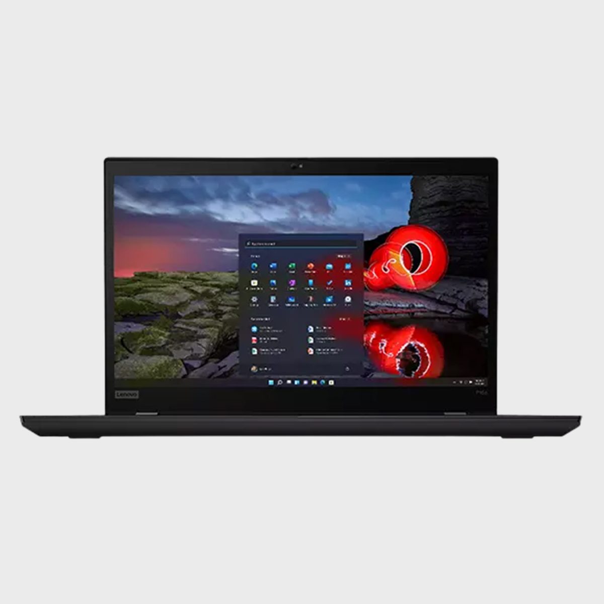 Laptop displaying desktop screen with a scenic wallpaper, showing a rocky landscape and vibrant sky. A start menu with app icons is open.