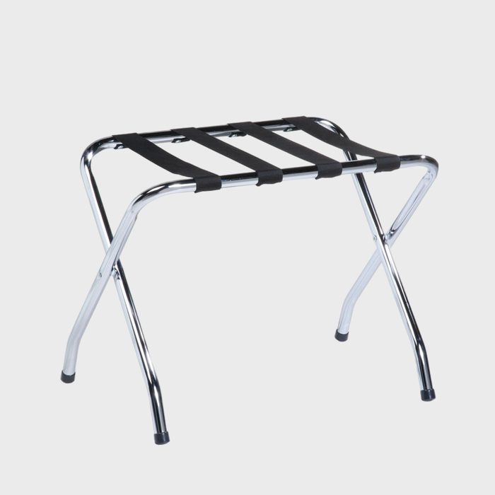 A metal luggage rack, with black straps, sits unfolded on a white background.