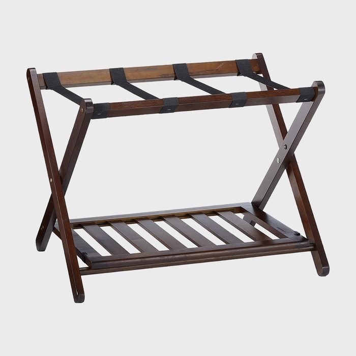 Wooden luggage rack stands unfolded with dark finish, featuring black fabric straps, against a plain white background.