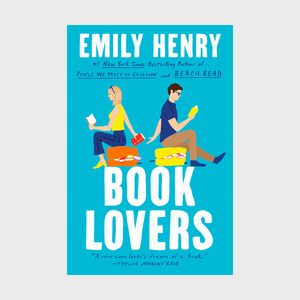 A man and woman read books back-to-back on suitcases; text reads 