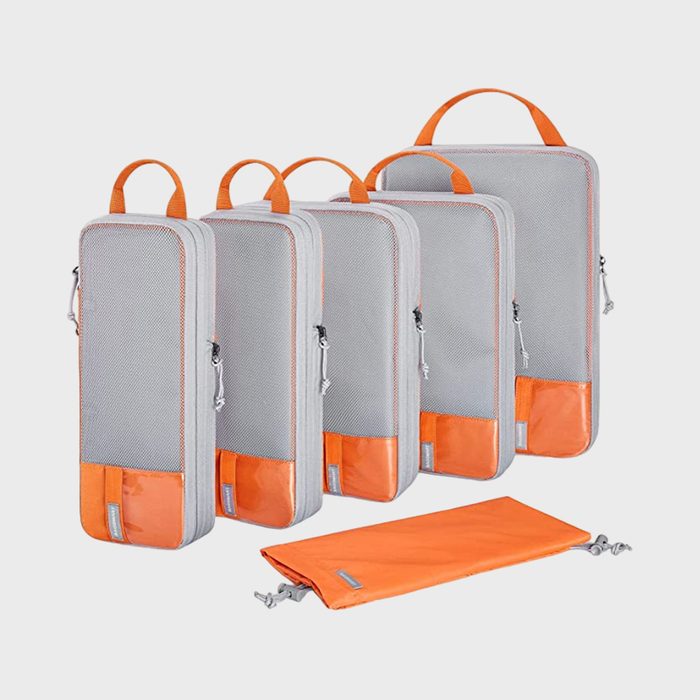 Five mesh travel bags with zippers and orange handles, standing upright, alongside a flat orange drawstring bag on a white background.