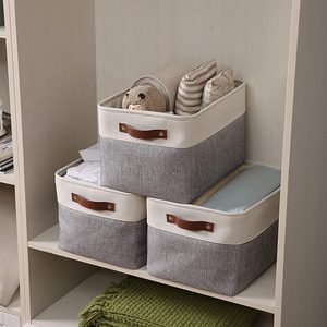Fabric storage bins hold assorted textiles on wooden shelves in a neat, organized closet setting.