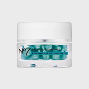 A clear jar contains blue capsules labeled 