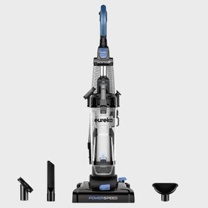 Vacuum cleaner stands upright with attachments on the floor; labeled 