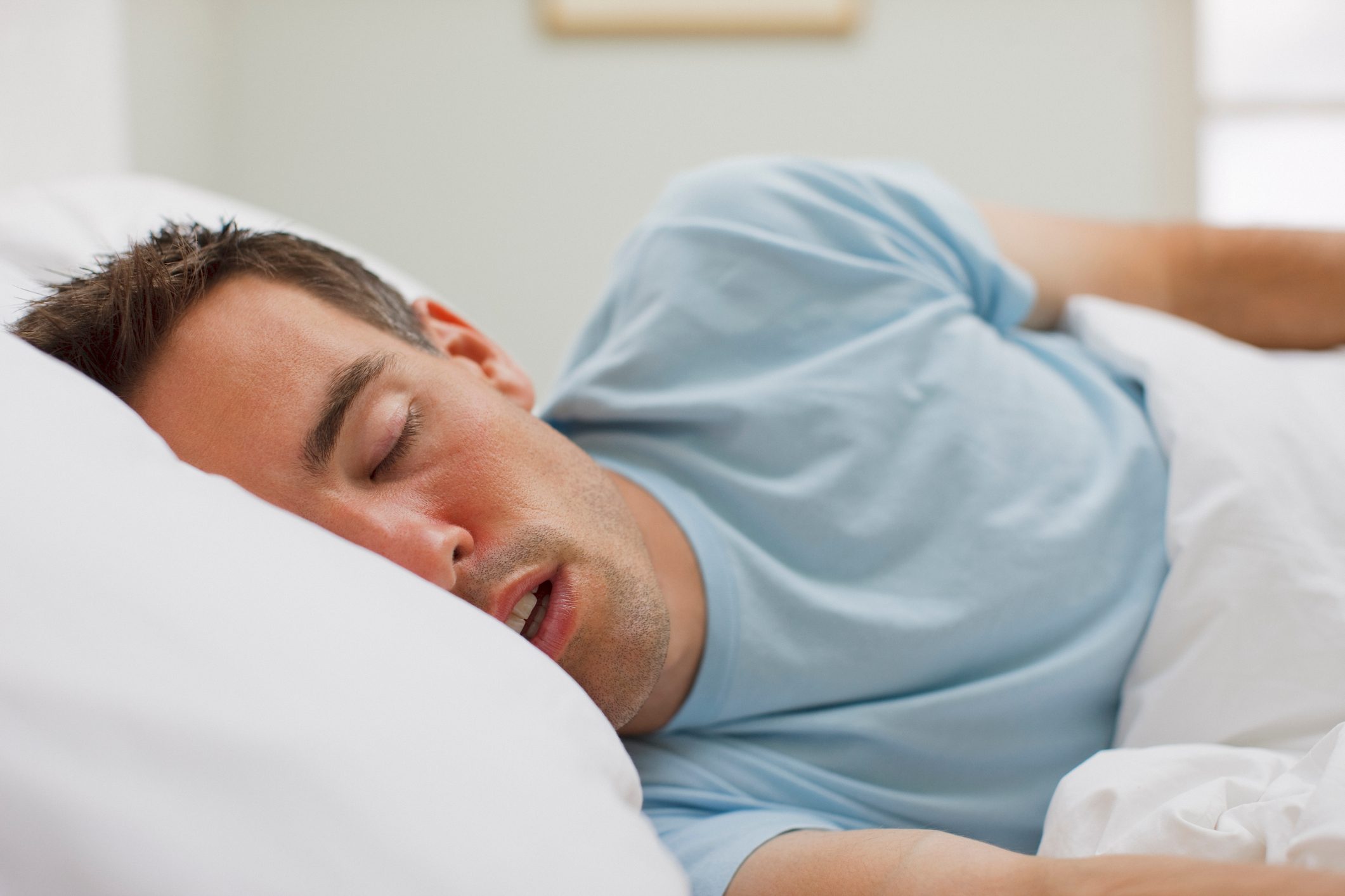 man sleeping in bed