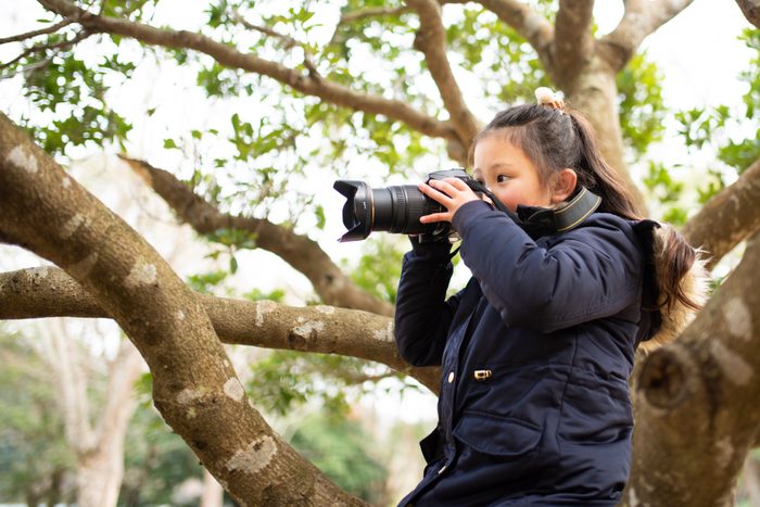Girl taking a picture with an SLR camera