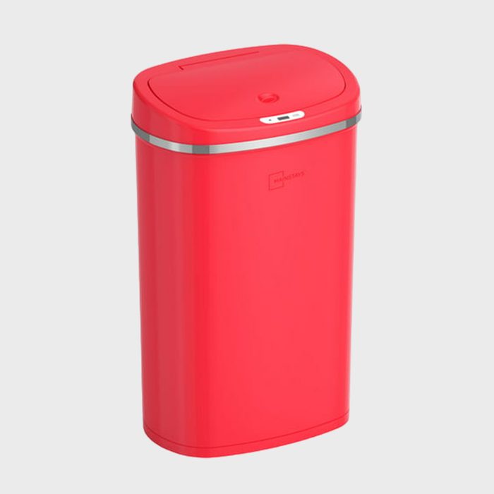A red trash can stands upright with a closed lid, placed against a plain gray background.