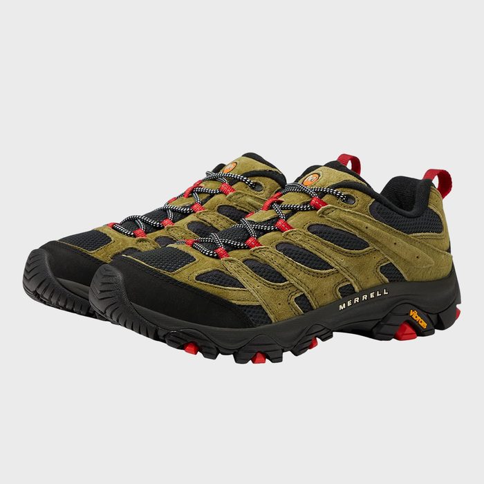 Hiking shoes feature olive green and black design with red accents, displayed in a studio setting. Text: 