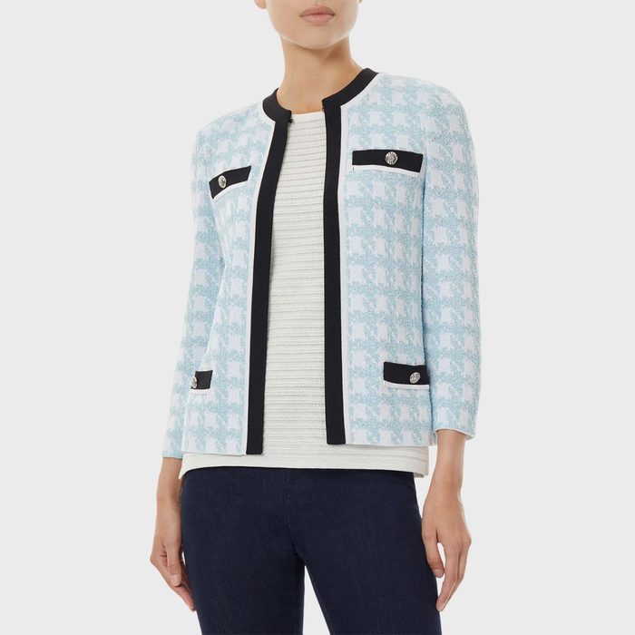 A light blue patterned jacket is worn over a white striped shirt, paired with dark jeans, against a plain background.