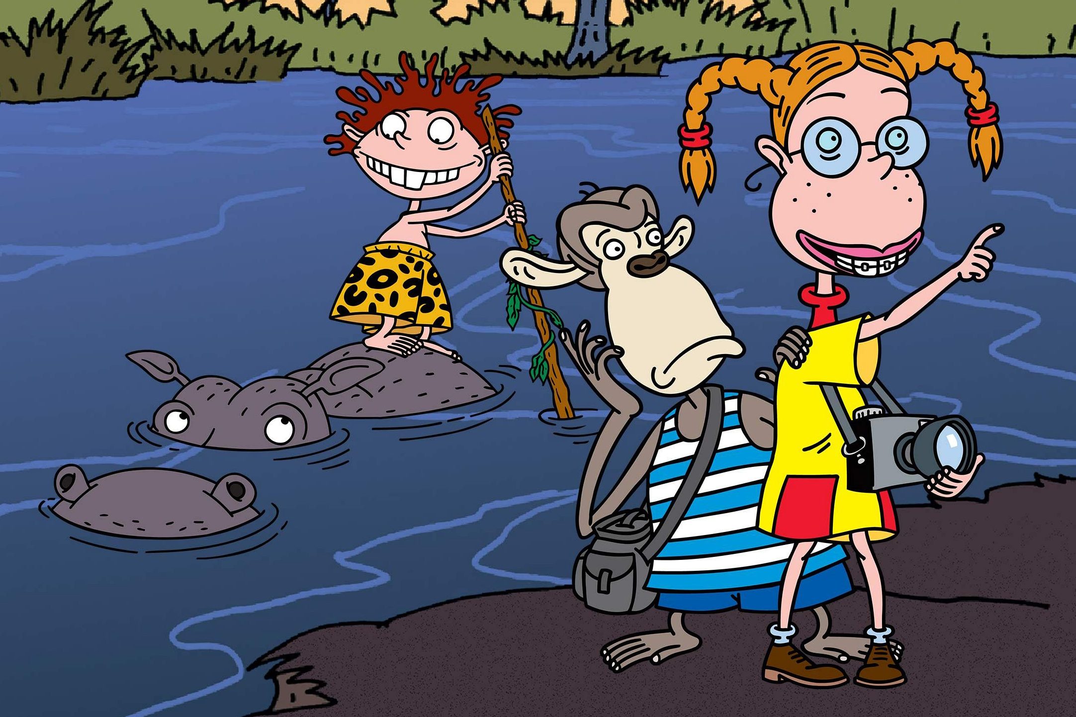 A girl with a camera points while a monkey watches, beside a child standing on a hippo in a jungle river.