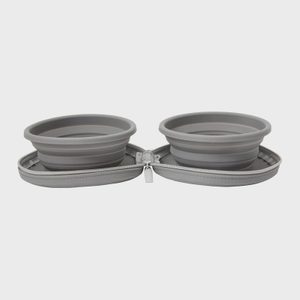 Two gray collapsible bowls rest open, secured within a gray zippered case in a minimalist setting.