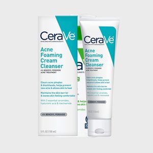 Tube and box display skin cleanser, featuring benzoyl peroxide for treating acne, against a plain background. Text highlights ingredients and benefits, emphasizing skin comfort.