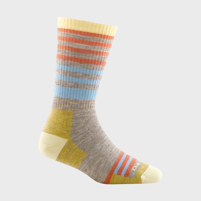 Striped sock displays colorful bands in orange, blue, and beige, with yellow heel and toe, against a plain gray background.