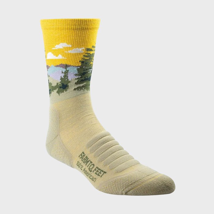 Sock displays a landscape design including trees and mountains against a yellow sky. The text reads 