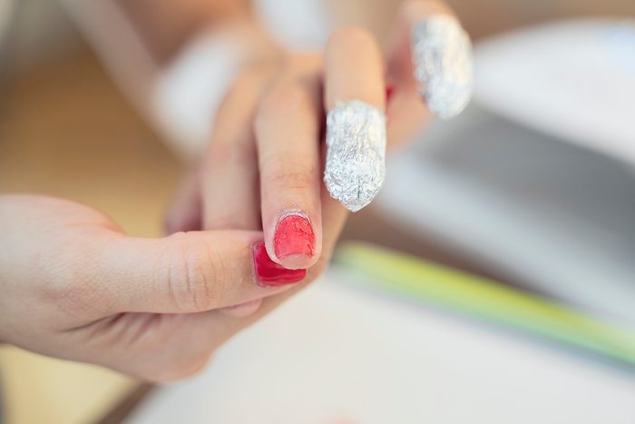 Removing nail polish from hand fingers with foil, damaging nails