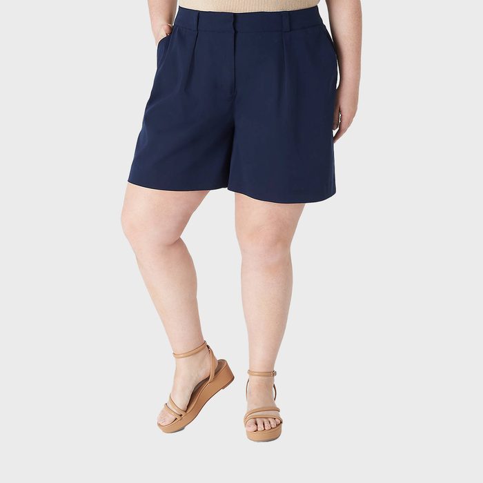 Navy shorts being modeled with hands in pockets, displayed against a plain background.