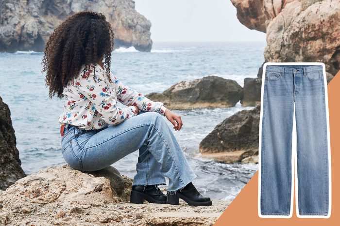A person sits on rocks overlooking the ocean, wearing floral shirt and jeans, next to a large image of straight-cut jeans.