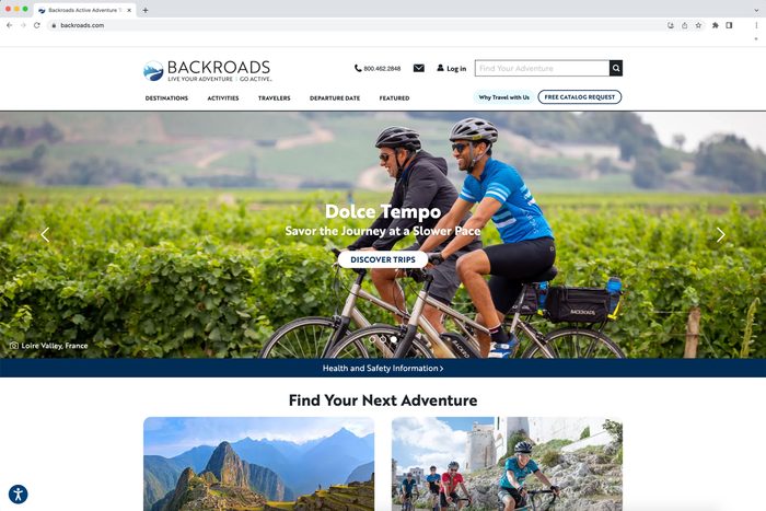 Cyclists ride through vineyards; text reads 