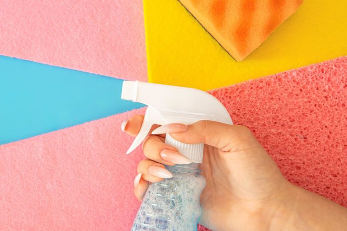 Cleaning Spray Bottle And Colored Rags Flat Lay alluding to windex