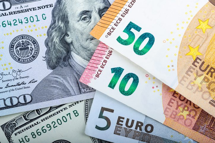 Different denominations on a gray background. 5, 10, 50 euros and 100 dollar US bills