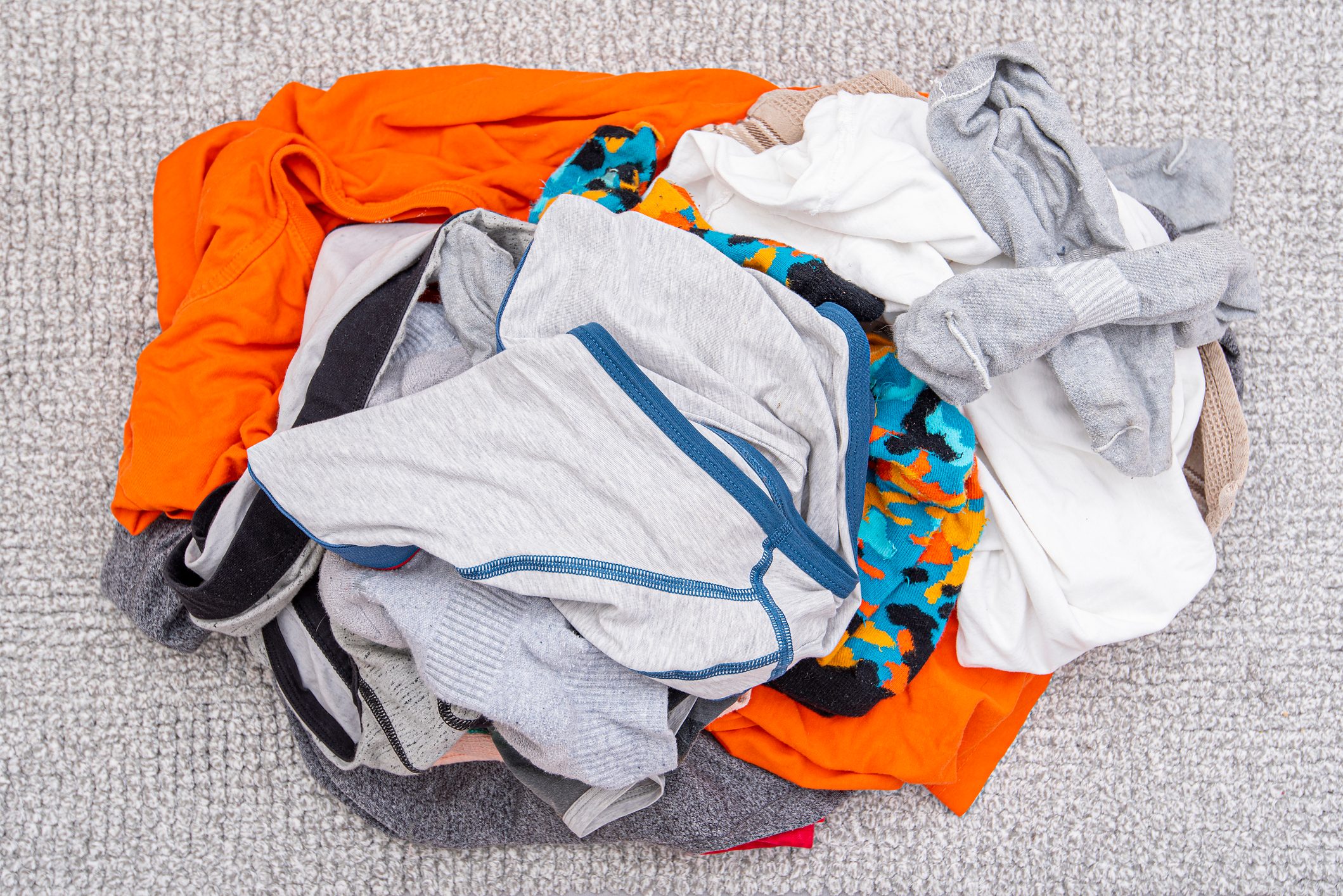 pile of dirty laundry and underwear on the floor
