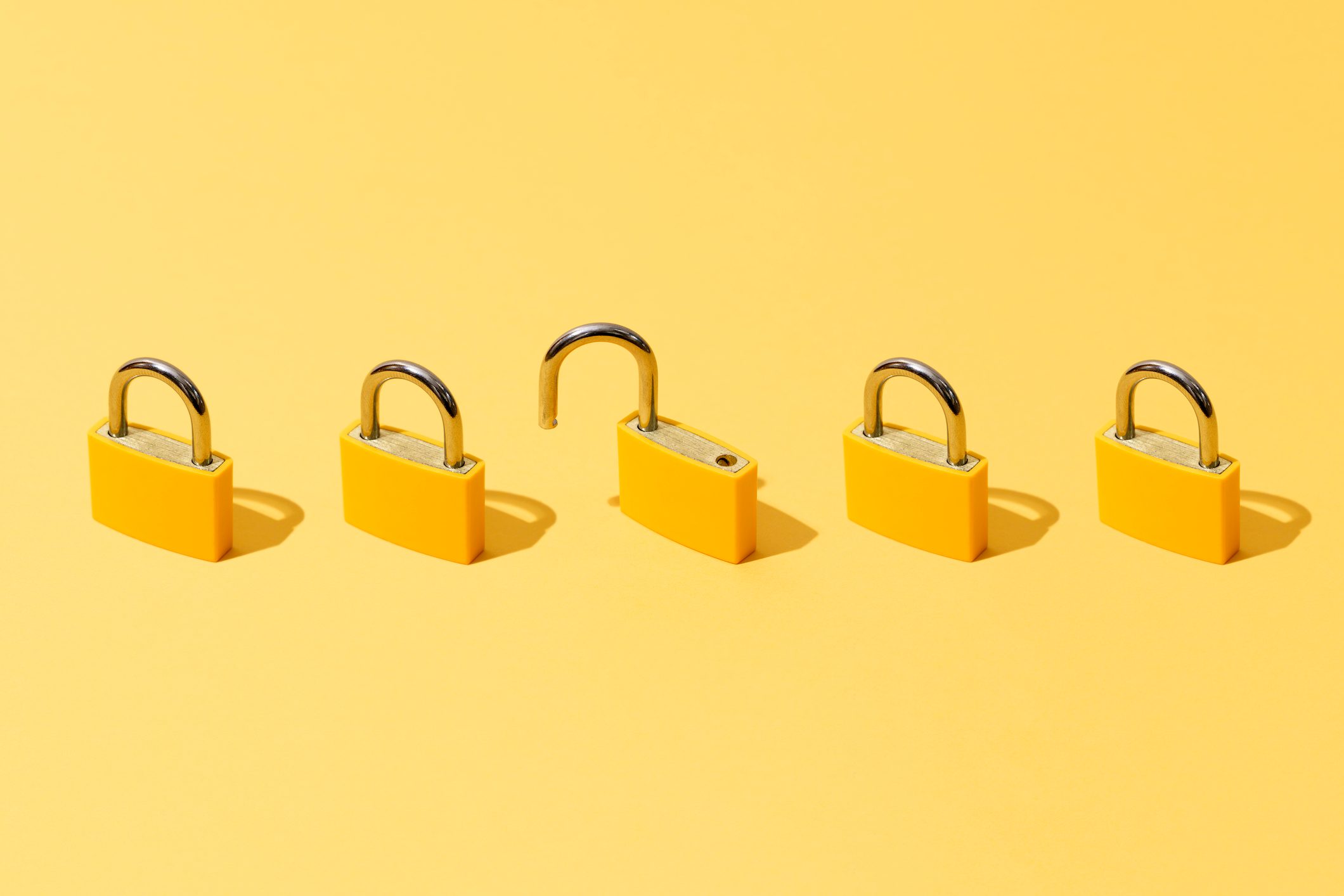 Five Yellow Padlocks On Yellow Background