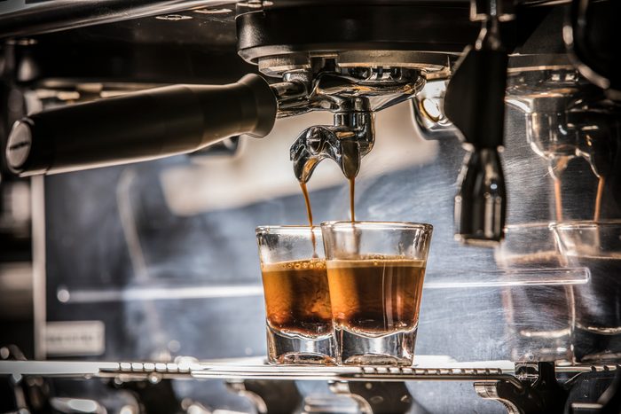 Espresso shot from the espresso machine with the mixed lighting of ambient and flash light