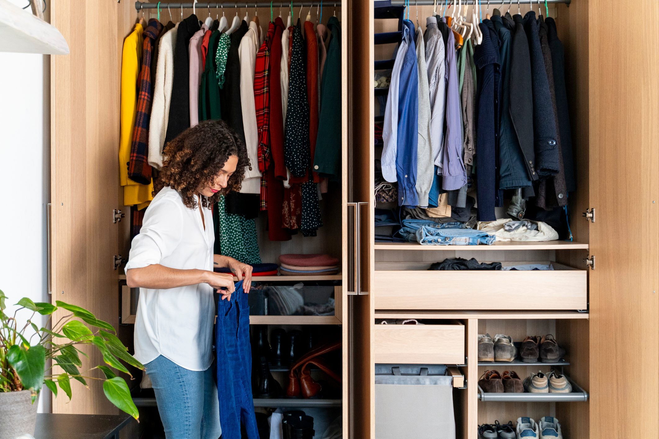 Woman clearing out her wardrobe