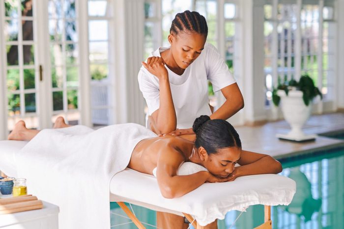 Shot of an attractive young woman getting a massage at a spa