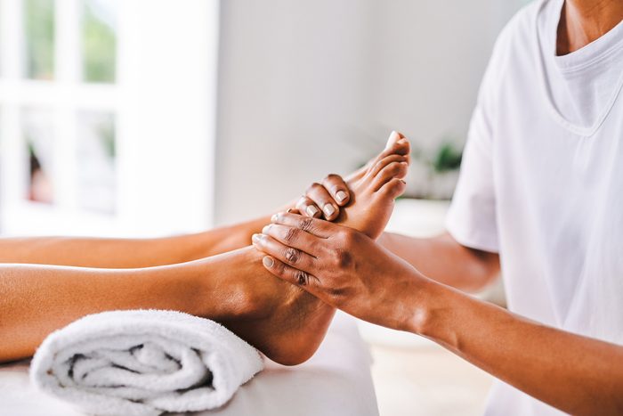 Shot of an unrecognisable young woman getting getting massaged at a beauty spa