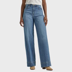 Jeans are being worn, styled with a high waist and wide leg, paired with a plain white top and brown boots, on a neutral background.