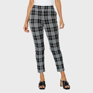 Plaid pants are worn by a standing person, paired with black sandals, set against a plain white background.