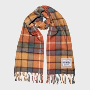 Scarf lies flat with fringed ends, featuring a multicolored plaid pattern. The label reads: 