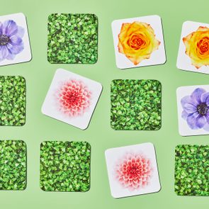 Cards display flowers and leaves, arranged randomly on a light green background, showcasing vibrant colors and patterns.