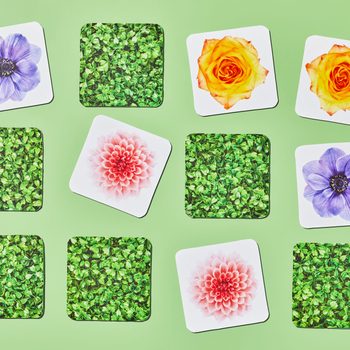 Cards display flowers and leaves, arranged randomly on a light green background, showcasing vibrant colors and patterns.