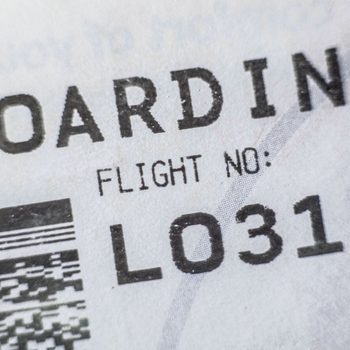 A boarding pass shows "FLIGHT NO: LO319" with a barcode on a paper background.