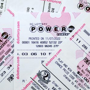 Lottery tickets display numbers and Powerball logos, overlapping randomly. Printed on 11/07/2022, associated with DC Lottery.