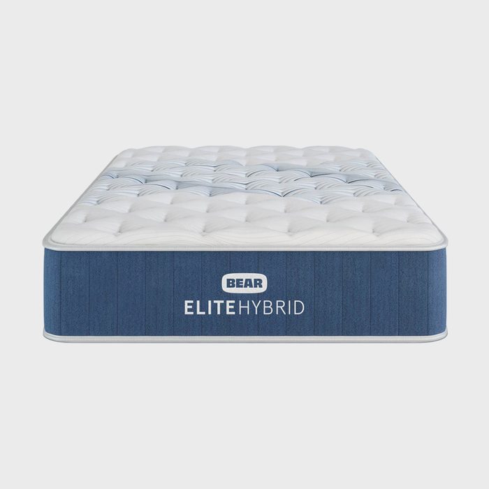Mattress sits in a plain setting, displaying 