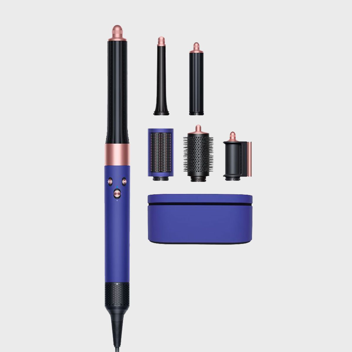 Hair styling tool set with multiple attachments laid out on a plain background, including curling barrels, brush heads, and a blue storage case.