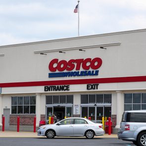 Storefront with cars parked, displaying 